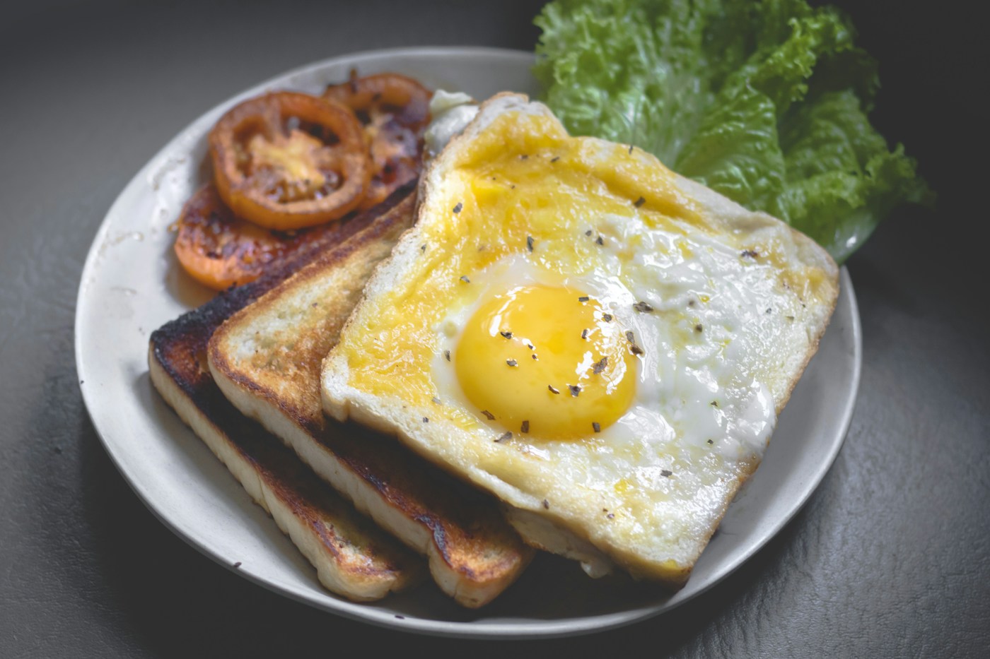 Illustrative breakfast with eggs, toast and fresh greens
